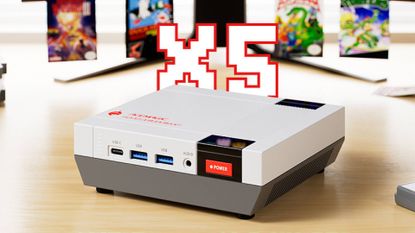ACEMAGIC Retro X5 mini PC on woodgrain desk with X5 text above and blurred NES box art in backdrop.