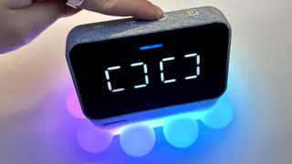 Lenovo Smart Clock Essential with Alexa plugged into an Lenovo Ambient Light Dock