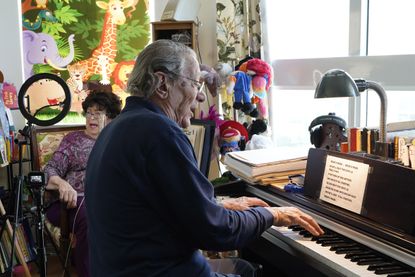 Peter and Veronica Fuchs sing in their apartment.