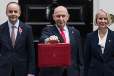 Britain's Chancellor of the Exchequer John Healey holds the red Budget box as she stands outside 11 Downing Street with HM Treasury Ministers