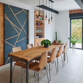 kitchen with white wall wooden dinning table and chairs
