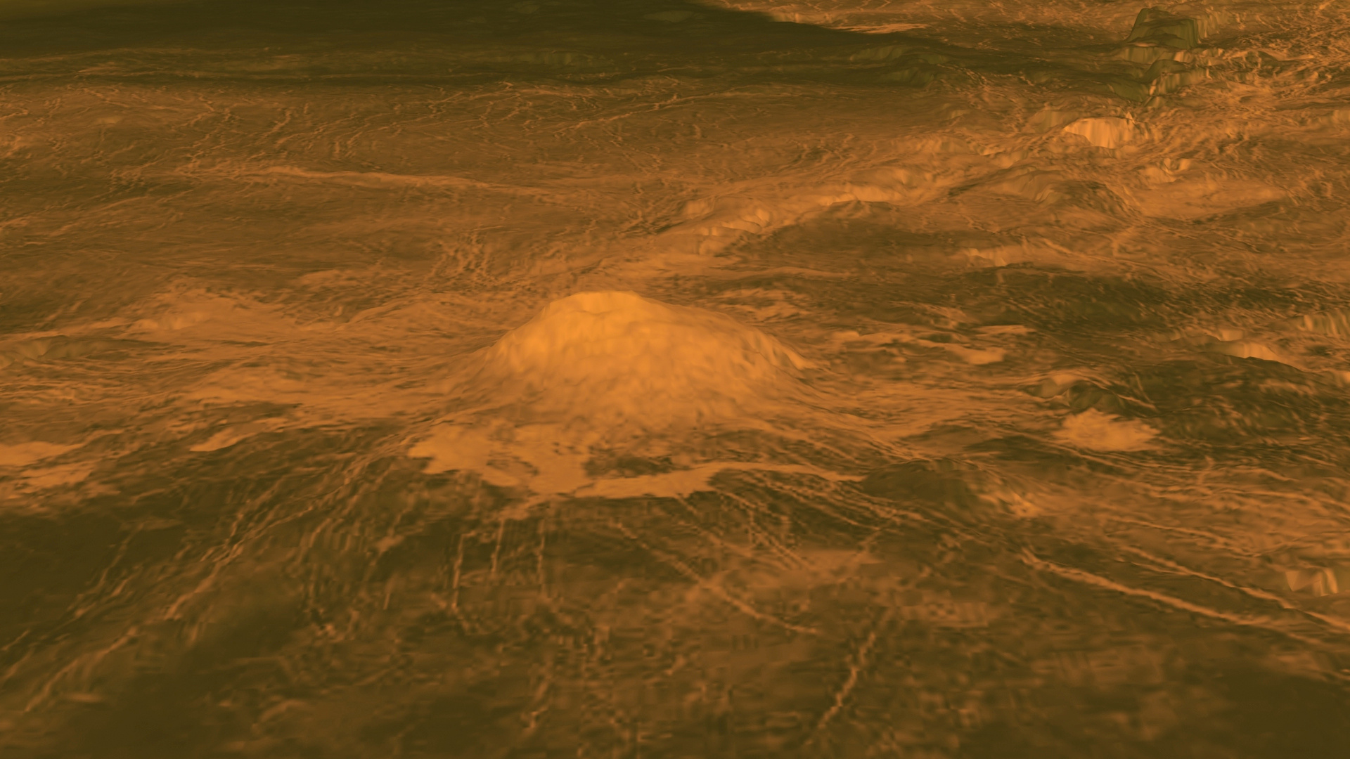 Orange hued image shows a peak (Idunn Mons volcano) rising up from the surface of Venus.