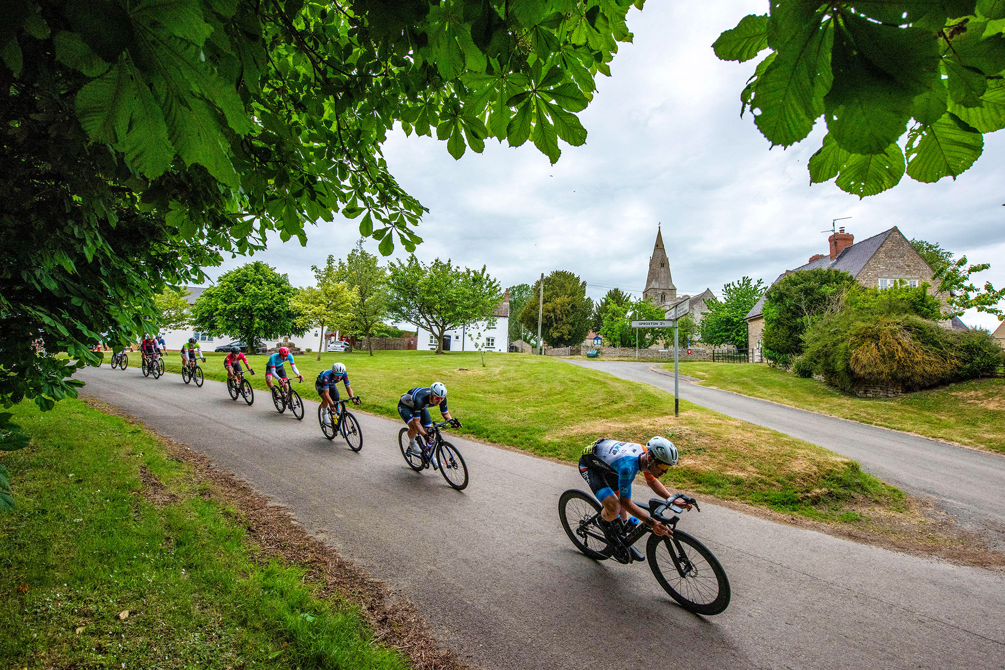 Riders pass St James Church in Skillington during the GA Bennett Road Race around Grantham, Lincolnshire, May 2025