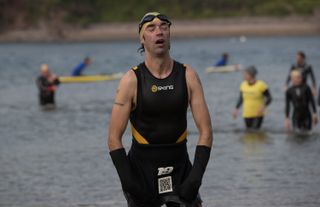 Swimmer exiting the water after the Bantham Swoosh