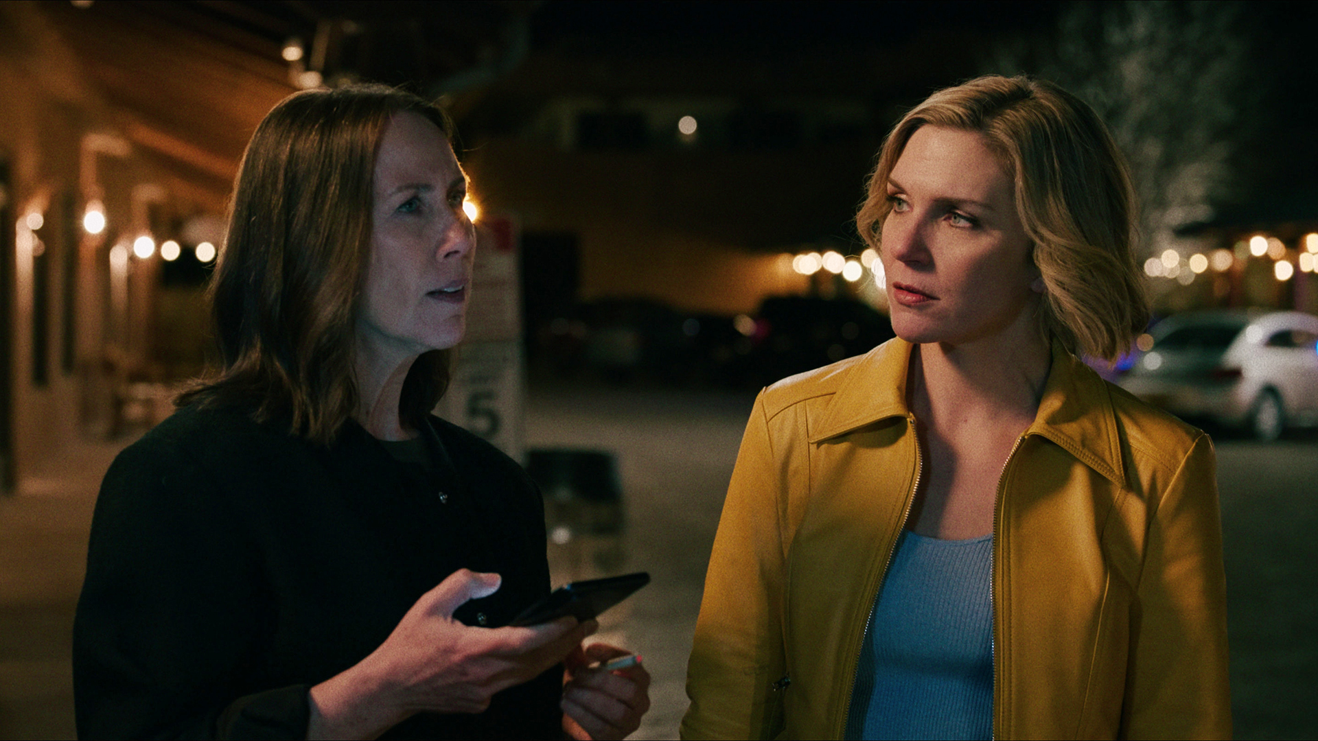 Helen holding her phone as Carol looks at her in Pluribus episode 1