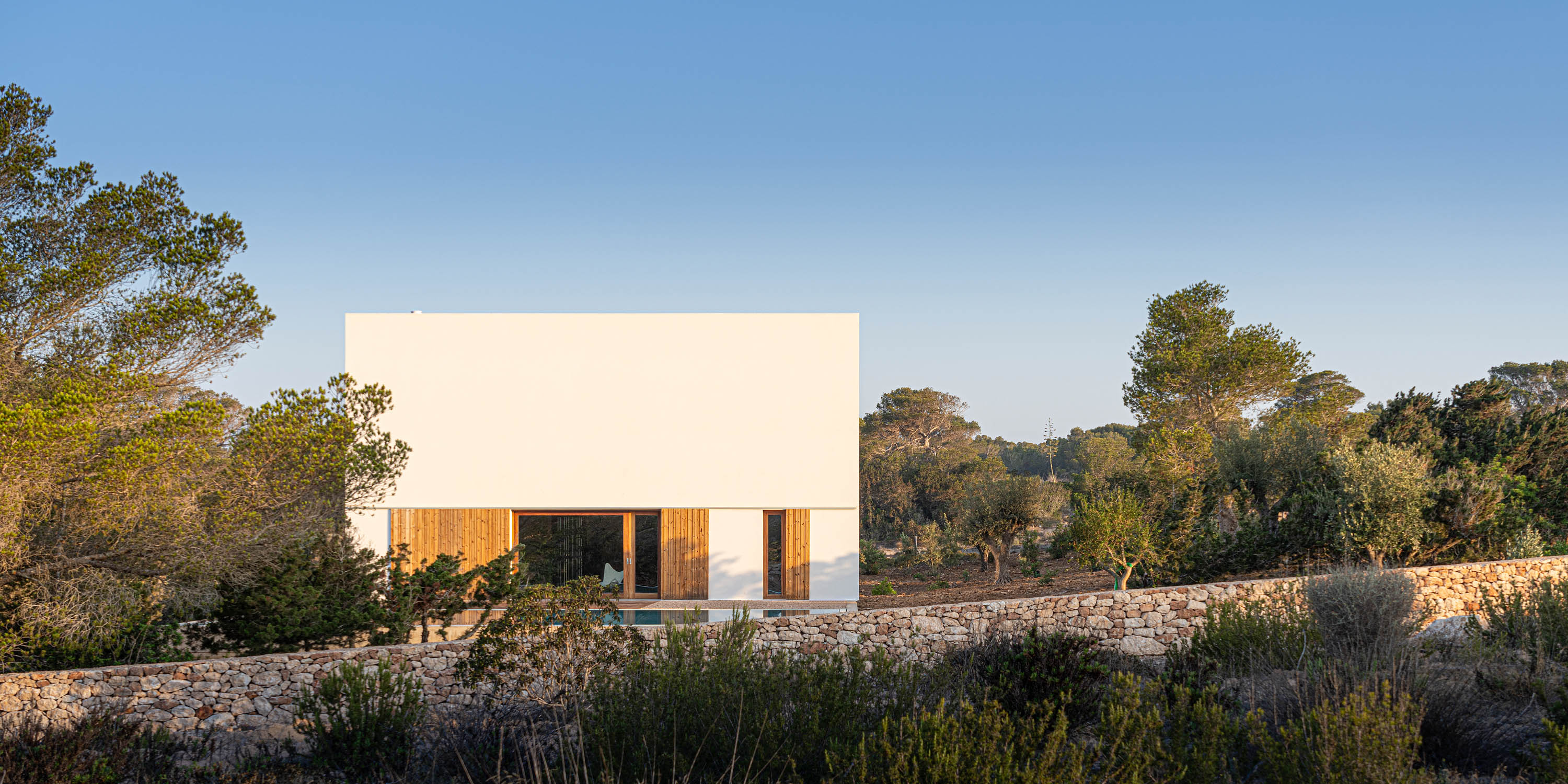 Formentera House by Mari&amp;agrave; Castell&amp;oacute;, a white concrete structure in the countryside
