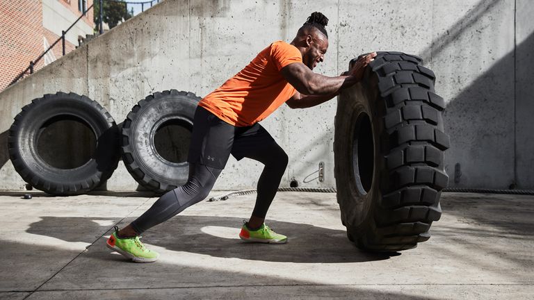Athlete flipping a tyre outside wearing the Under Armour TriBase Reign 4 Pro