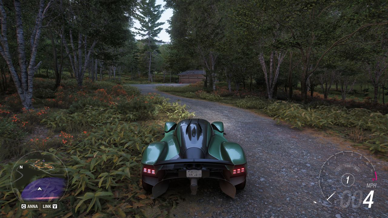 Forza Horizon 6 Barn Finds: A player parked on a dirt path leading to a barn in the woods.