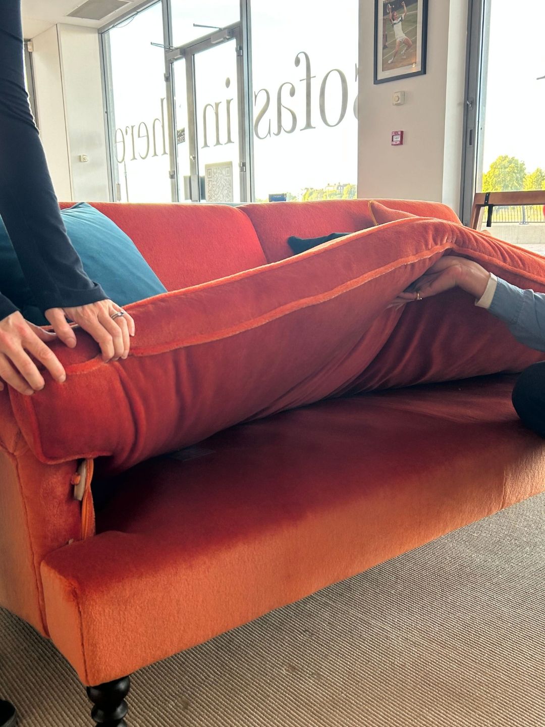 Close-up of the Schplendid Ablion sofa with its seat cushion lifted to reveal the internal support structure beneath the seat bench.