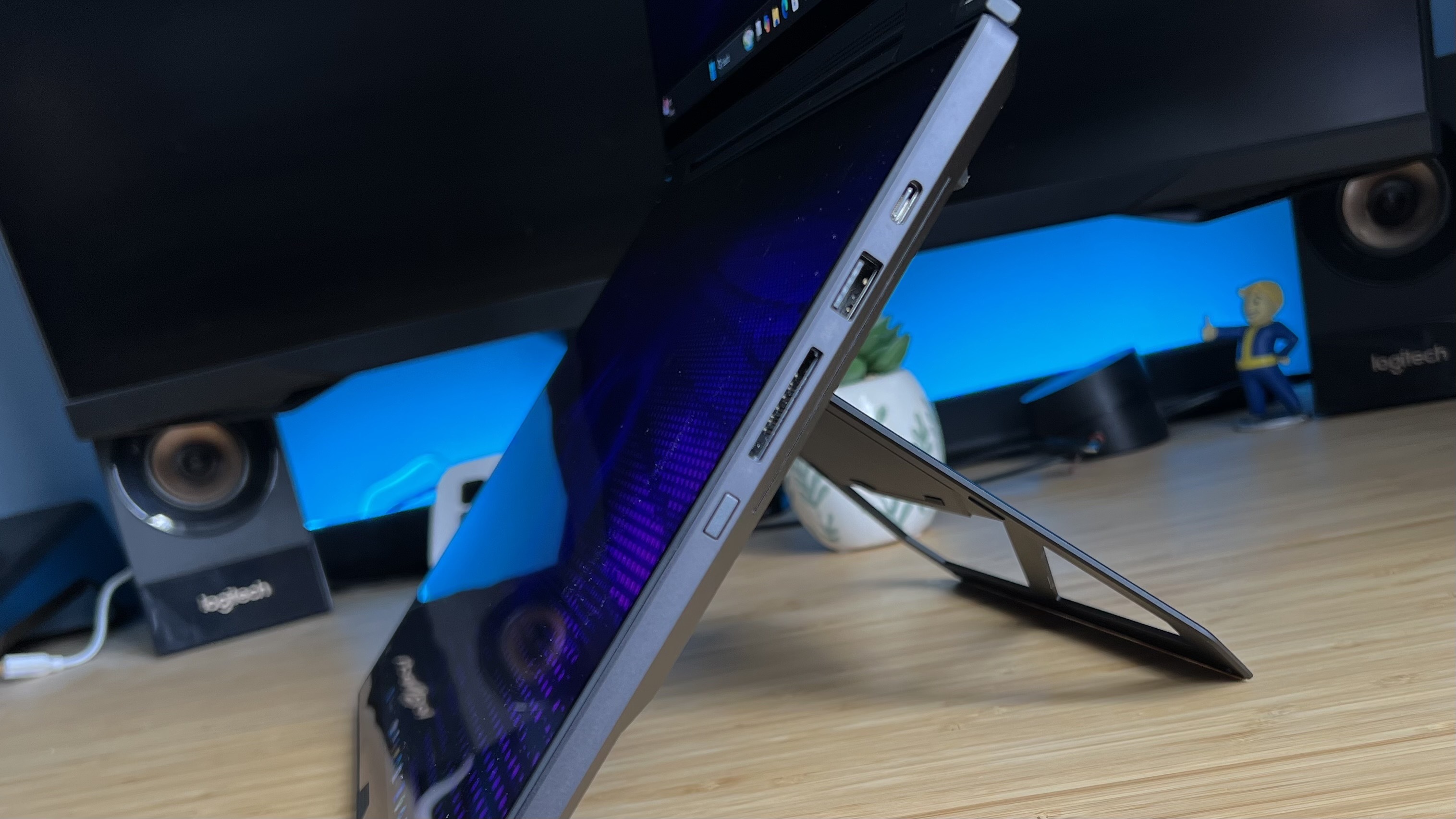Close up of hinge on the underside of Asus ROG Zephyrus Duo, while fully extended on a wooden desk