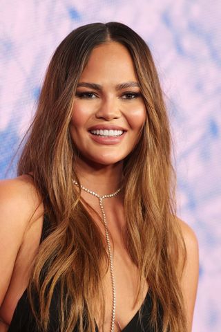 Chrissy Teigen with long layered hair.