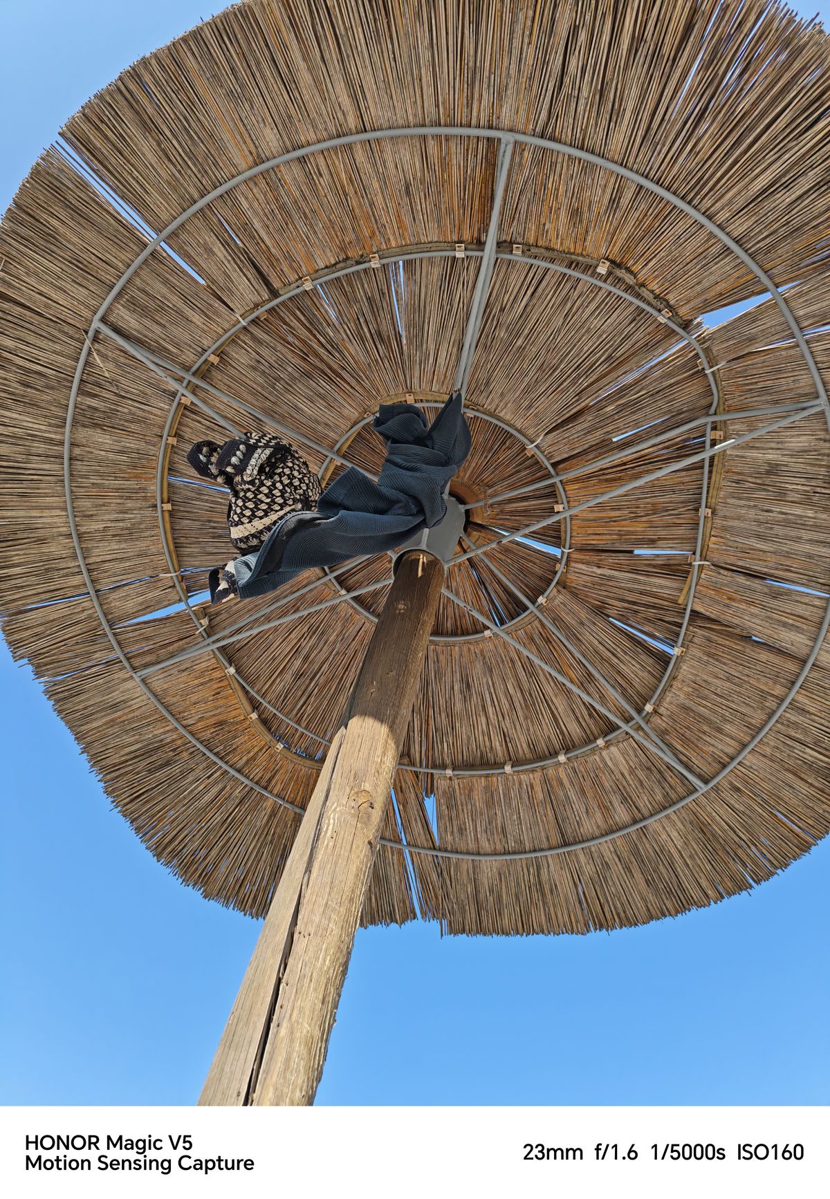 View under a parasol with shirts hanging