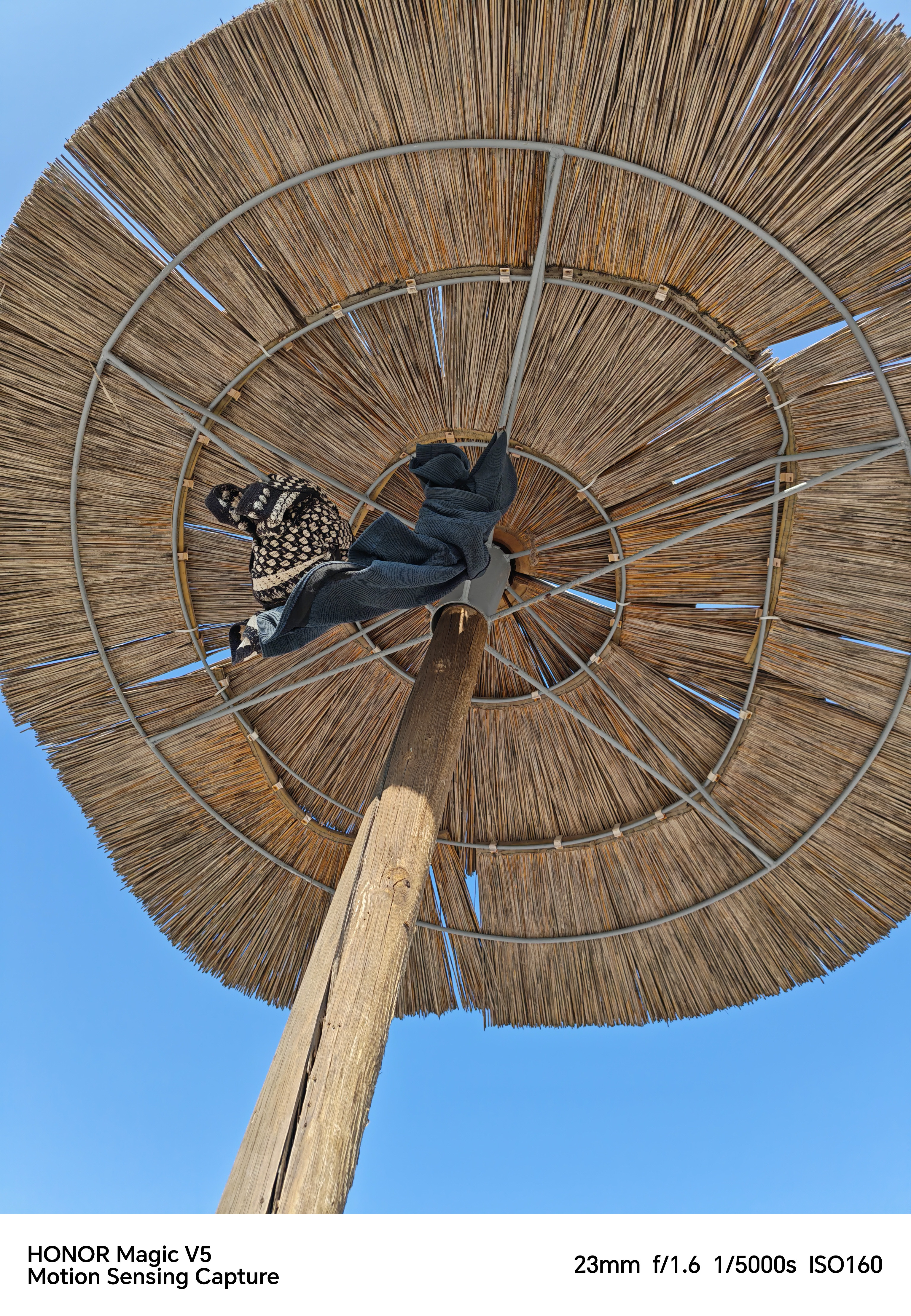 View under a parasol with shirts hanging