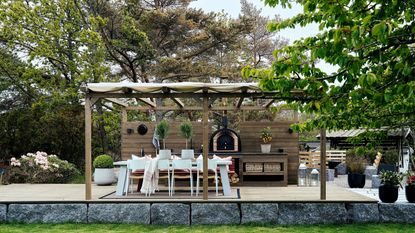 an outdoor kitchen on a stone platform featuring Lundhs stone