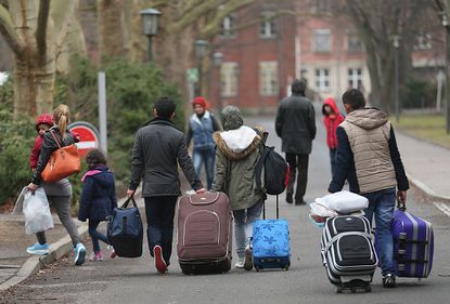 People arrive at the Central Registration Office for Asylum Seekers in Berlin