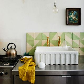 block print tiles with brass taps and steel cabinet