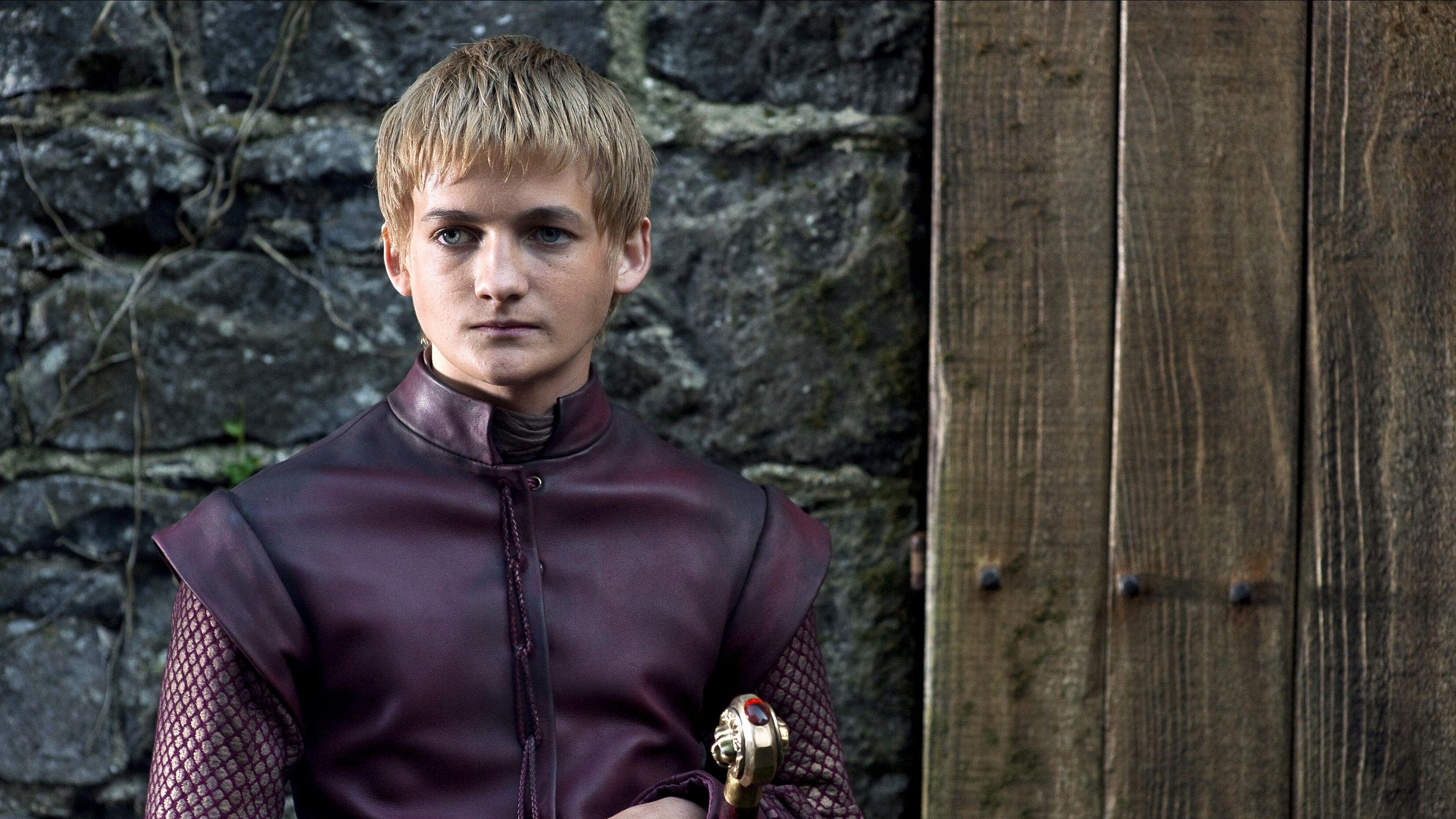 Jack Gleeson as King Joffrey in burgundy in Game of Thrones