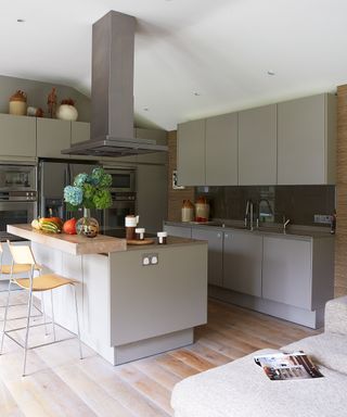 Kitchen layout ideas in a modern gray scheme with central island and breakfast bar.