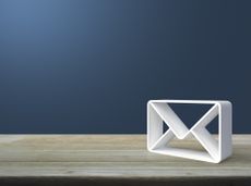 Mail 3d icon on wooden table over light blue wall