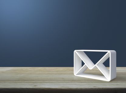 Mail 3d icon on wooden table over light blue wall