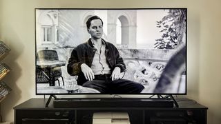 Panasonic W95A TV on table in living room