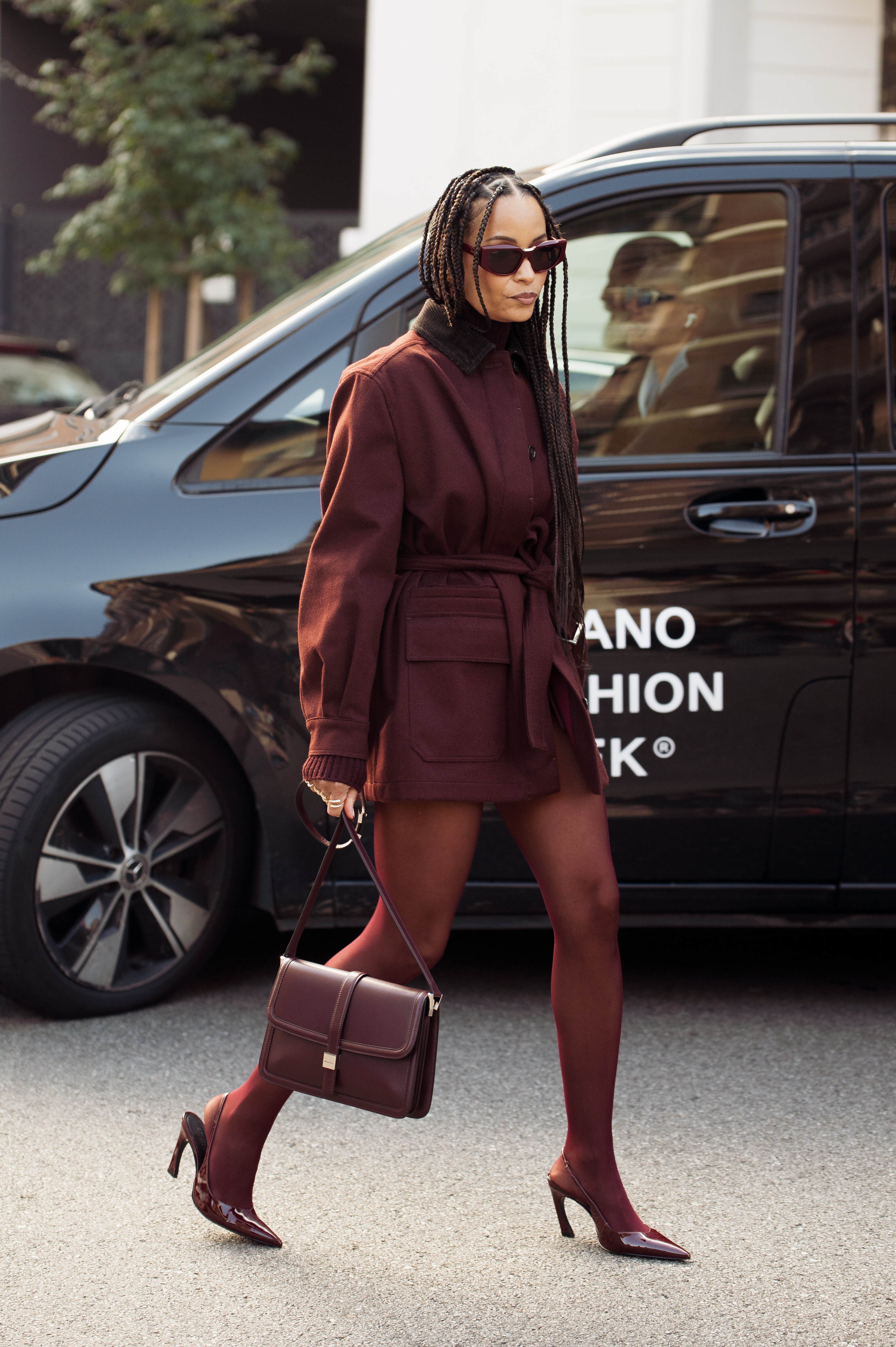 Sai De Silva wearing burgundy shoes.