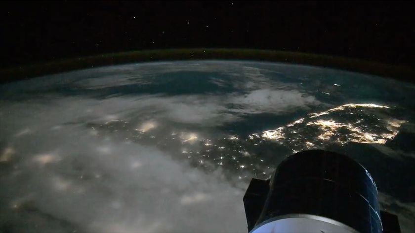 a lights from cities along the coast of a peninsula are seen at night from space