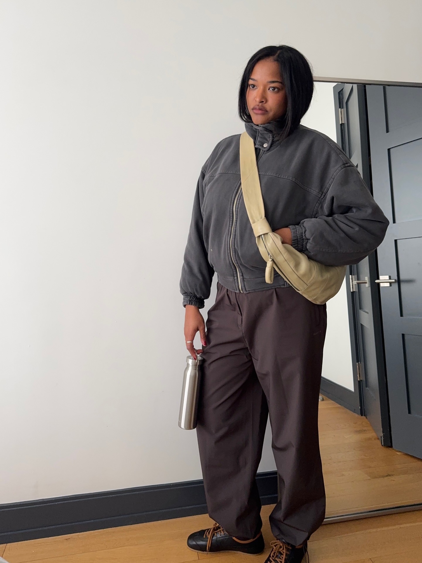 Influencer wearing sneakers with brown track pants