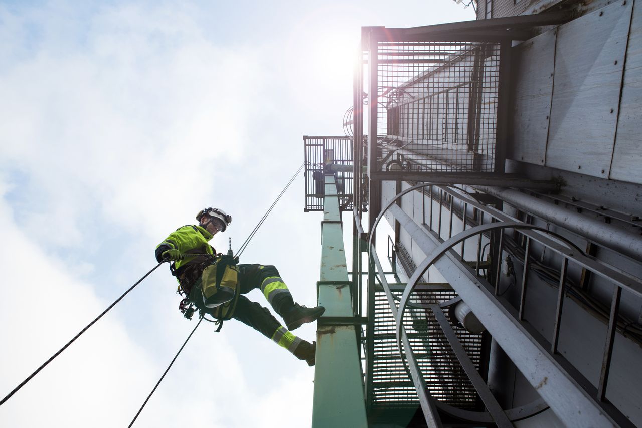 Man working from tower.