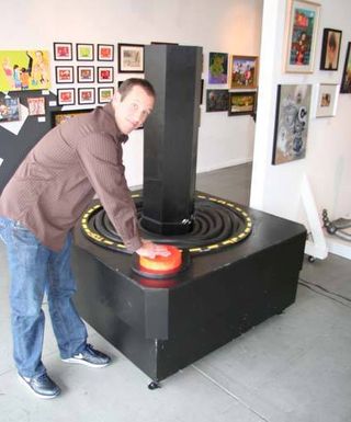 THG video producer Ben Meyer plays with the five and a half foot tall Atari 2600 joystick exhibit, which can actually be used as a working controller.