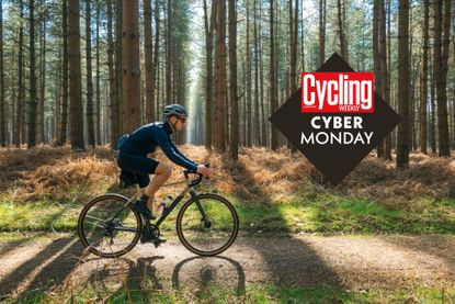 Image shows a cyclist riding through a forest on a gravel bike