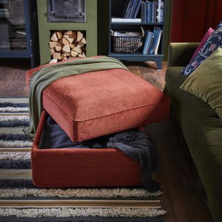 small living room with orange footstool and high pile area rug