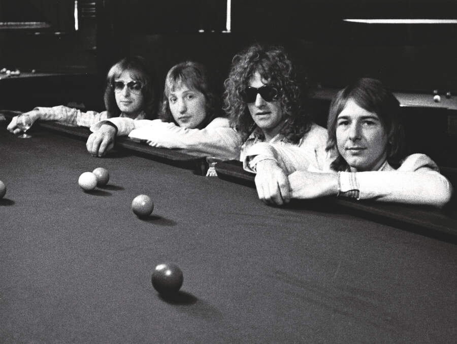 Mott the Hoople pose next to a snooker table