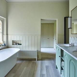 Large bathroom with double-sink vanity and freestanding bath