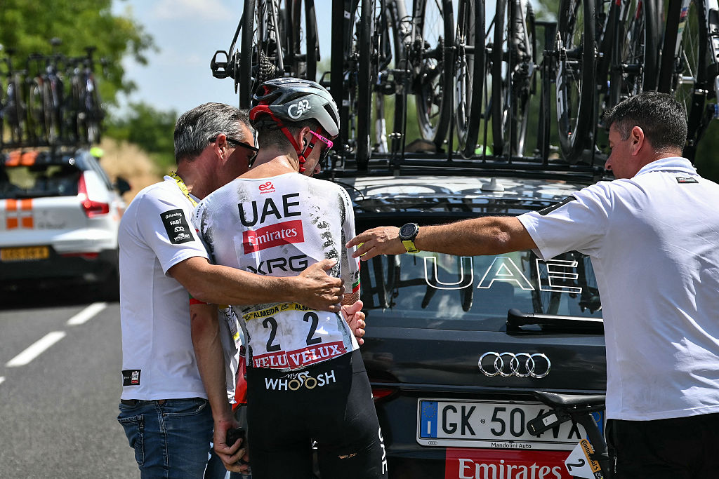 UAE Team Emirates - XRG team's Portuguese rider Joao Almeida boards his team support vehicle as he withdraws from the race on injury, during the 9th stage of the 112th edition of the Tour de France cycling race, 174.1 km between Chinon and Chateauroux, central France, on July 13, 2025. (Photo by Marco BERTORELLO / AFP)
