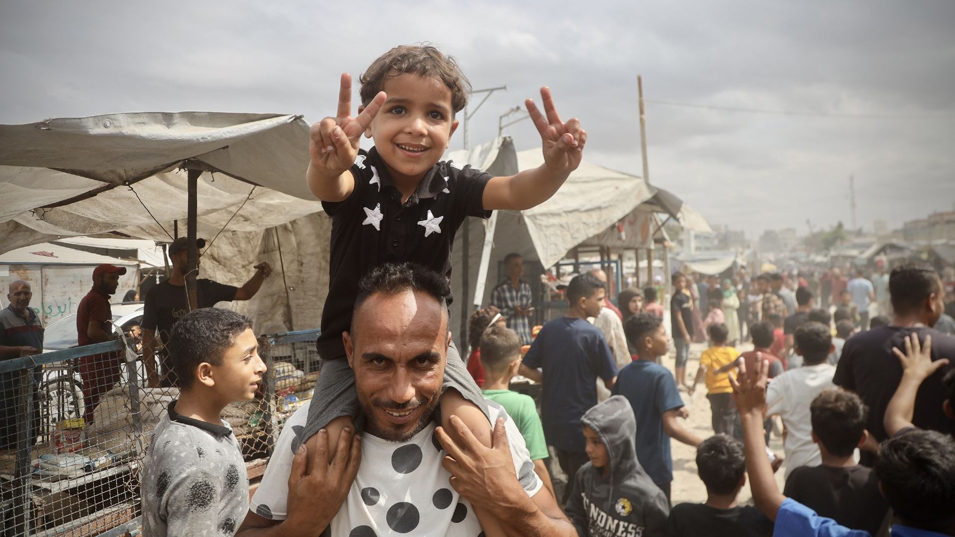 
                                Palestinians celebrate after Israel and Hamas agree to a peace deal, in Khan Yunis, Gaza Strip
                            