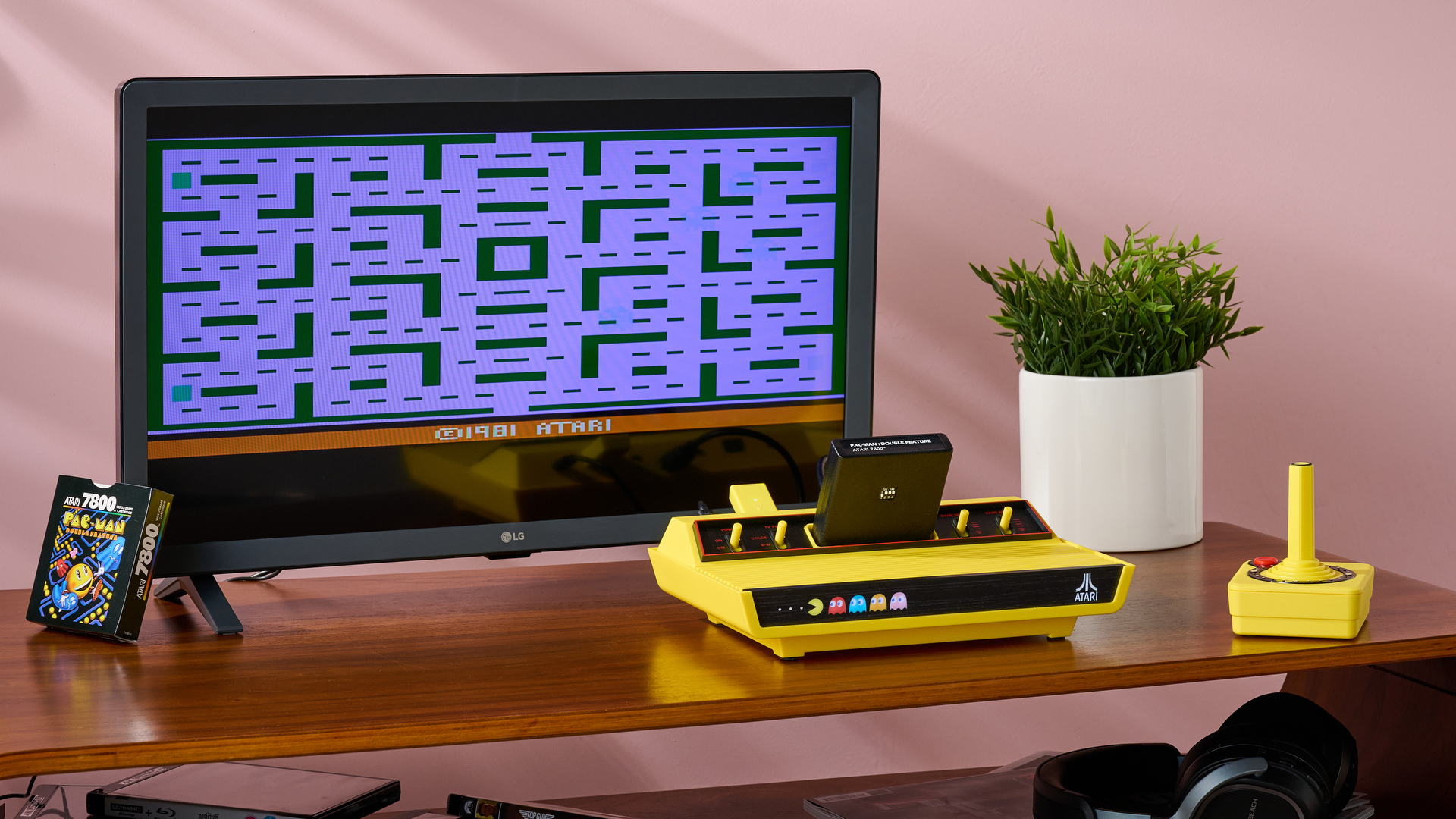 The Atari 2600+ Pac-Man Edition and CX40+ set up and plugged into the LG TQ520S-P, with Pac-Man 2600 on the screen.