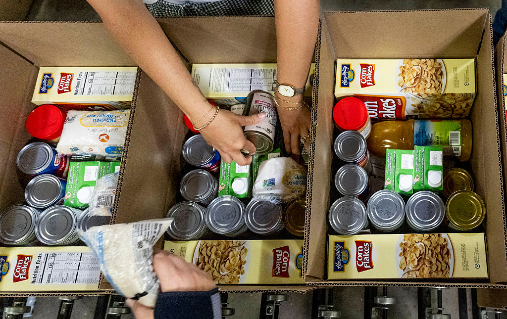 Workers pack boxes for the Commodity Supplemental Food Program at The Orange County Food Bank in Garden Grove, CA on Friday, May 9, 2025. The program serves about 25,000 local lower-income seniors. The program could lose federal money if the Trump administration's preferred 2026 federal budget becomes law.