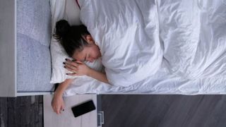 A woman is sweating in bed as she is a hot sleepers