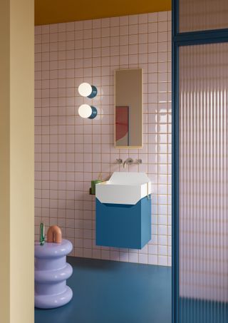 A colorful bathroom with pink tiles and orange tile grout