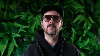 Shuyler Jansen standing in front of a tree