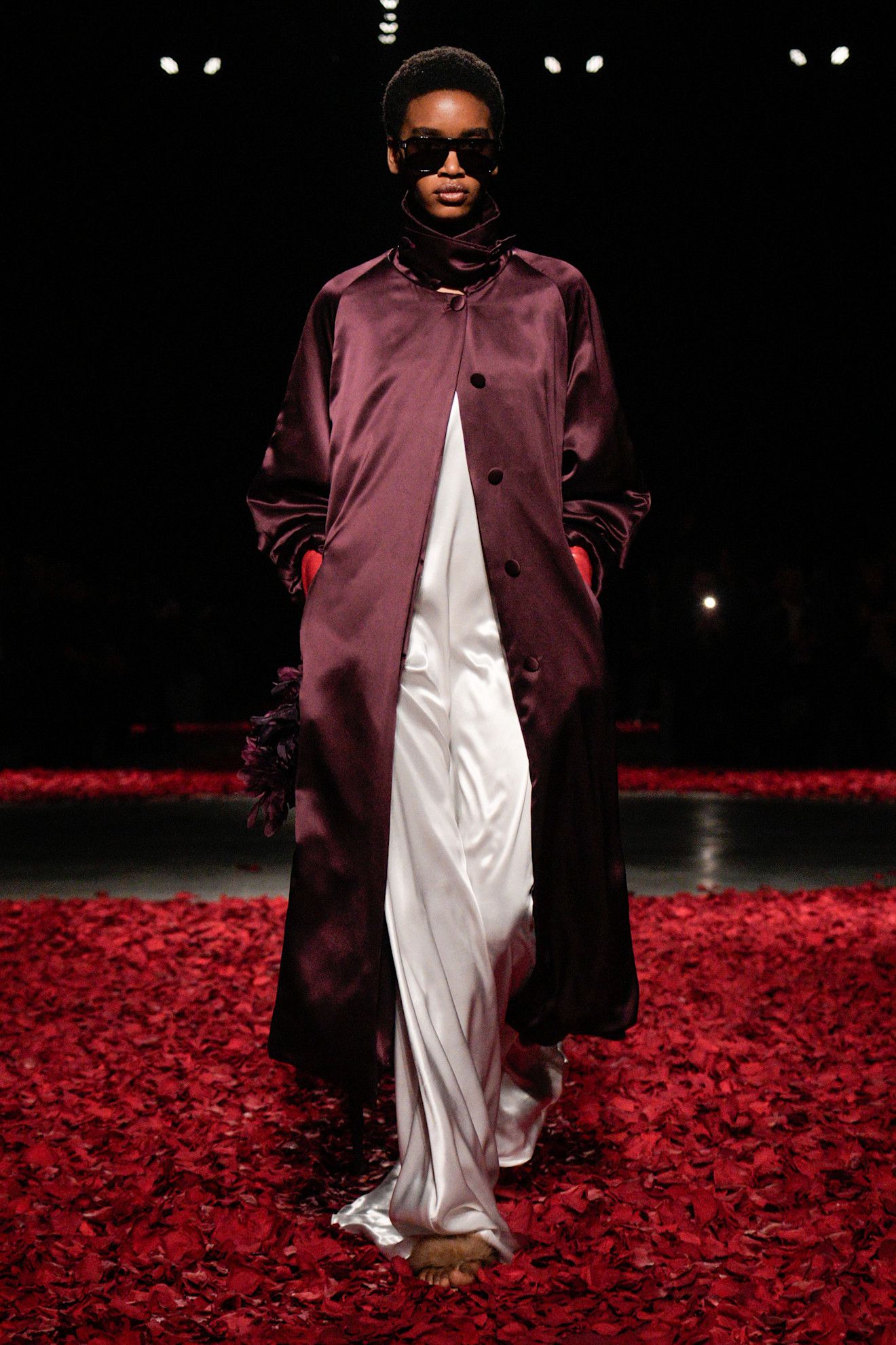 An image of an aubergine coat on Ferragamo's autumn/winter 2025 runway.