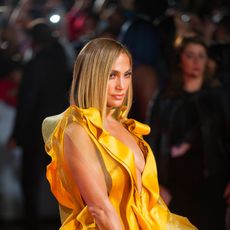 Yellow, Fashion, Hairstyle, Fashion model, Event, Premiere, Long hair, Dress, Flooring, Red carpet, 