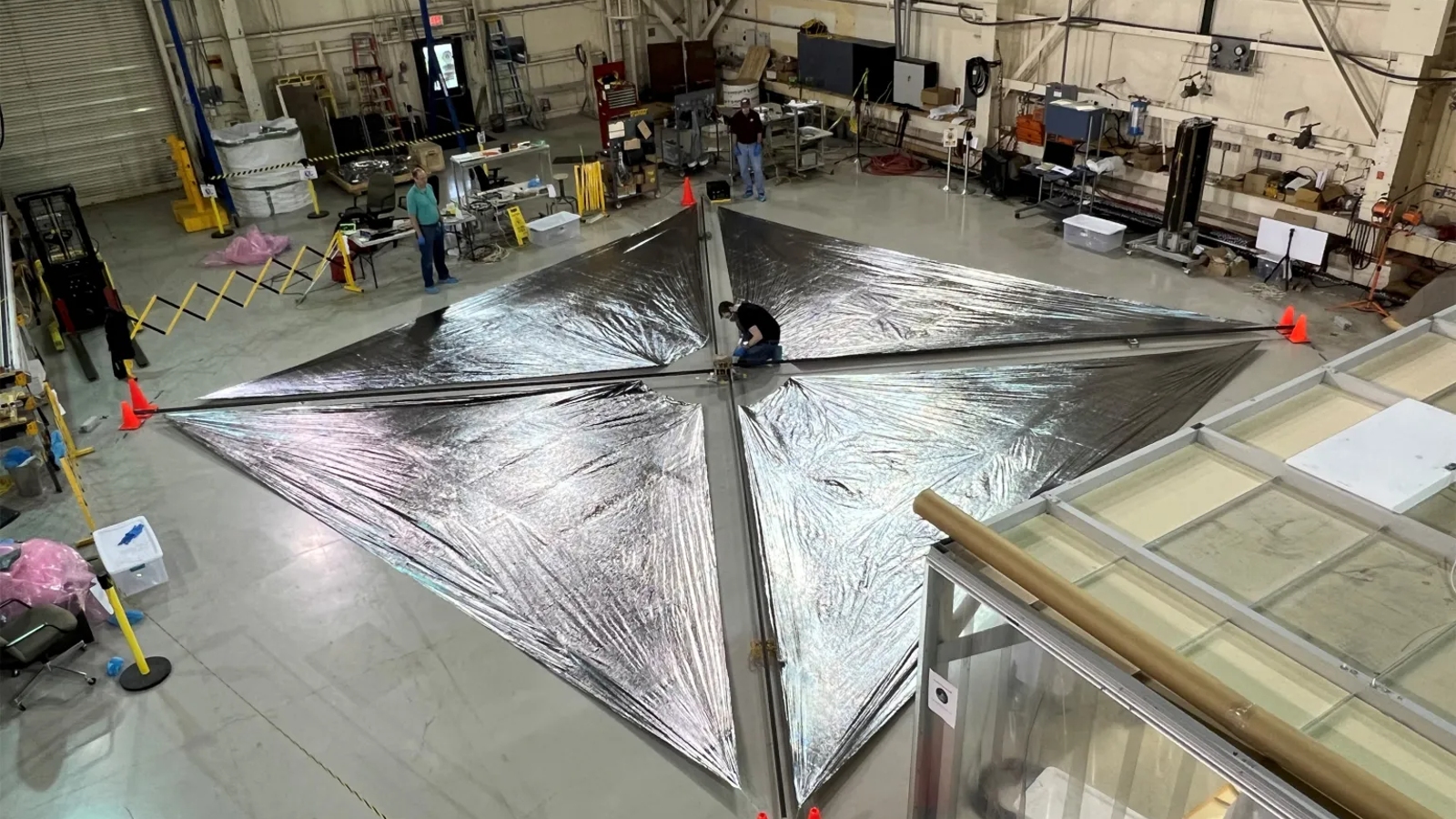 The solar sail laid out on a warehouse floor