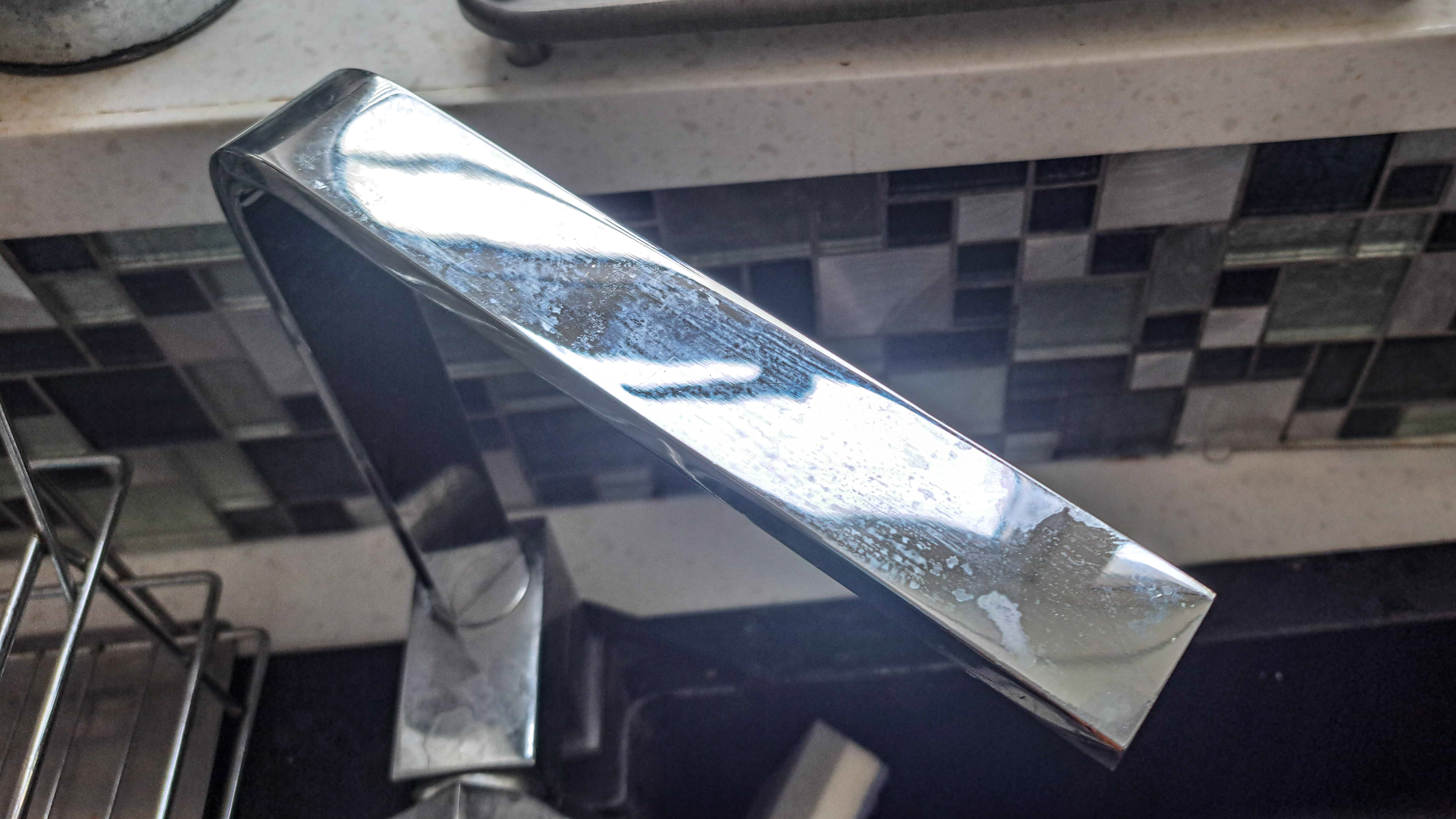 Water marks on faucet before cleaning with foil