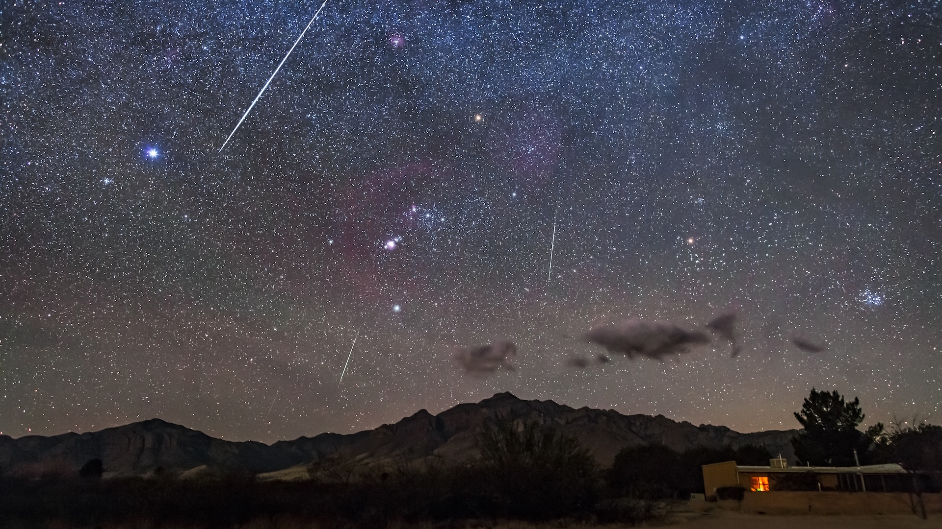 a photo of a meteor shower over the desert at night