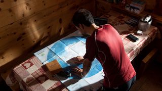 Omar Di Felice studies a map of Antarctica