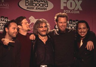 Michael Kamen (center) with Metallica, winners of two 1999 Billboard Music Awards