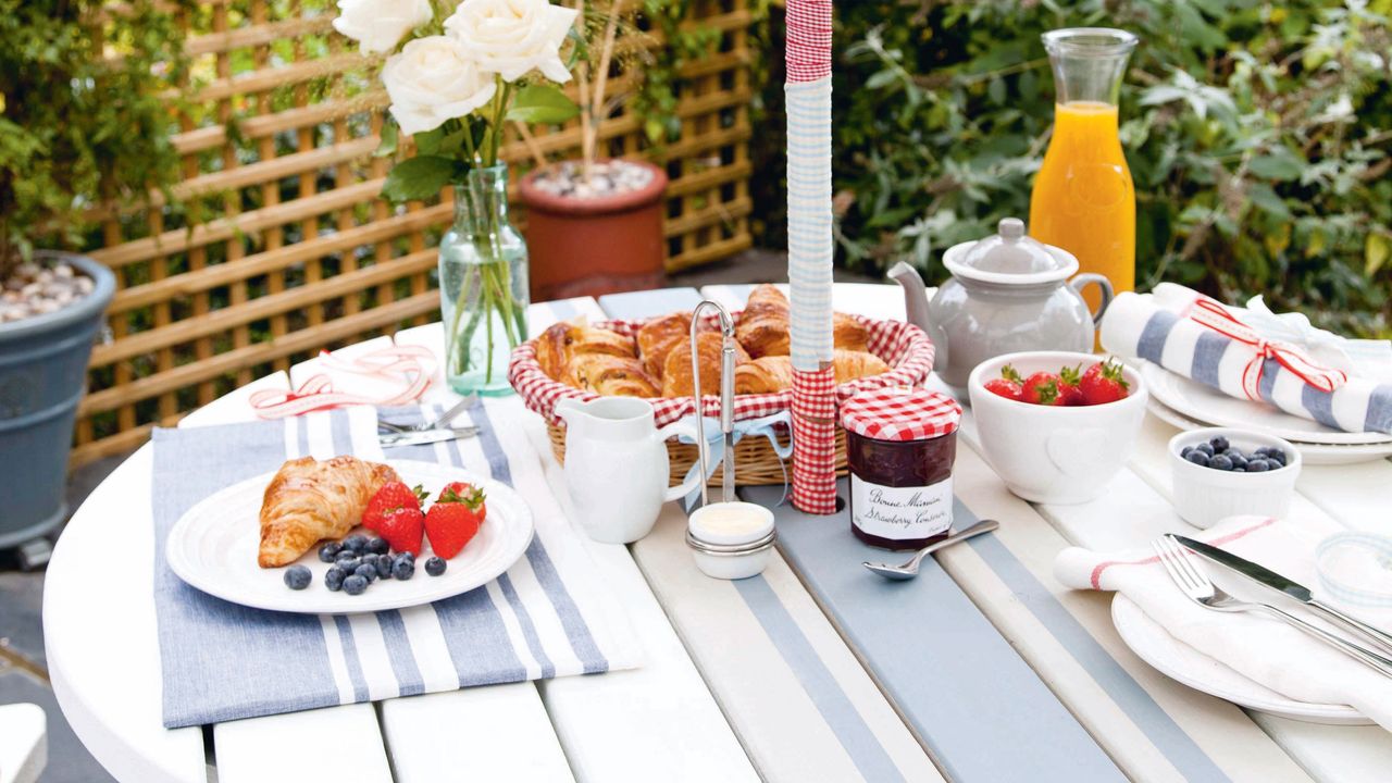 Picnic table painted with white and blue stripes