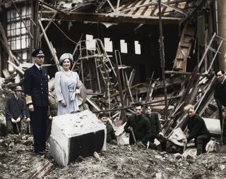 The King and Queen survey bomb damage, Buckingham Palace, London, WWII, 1940. King George VI and Queen Elizabeth looking at the aftermath of a German bombing raid on 11 September 1940 which destroyed the palace chapel. After the event the Queen famously said I'm glad we have been bombed. Now I can look the East End in the face. The palace was bombed on seven occasions during the war